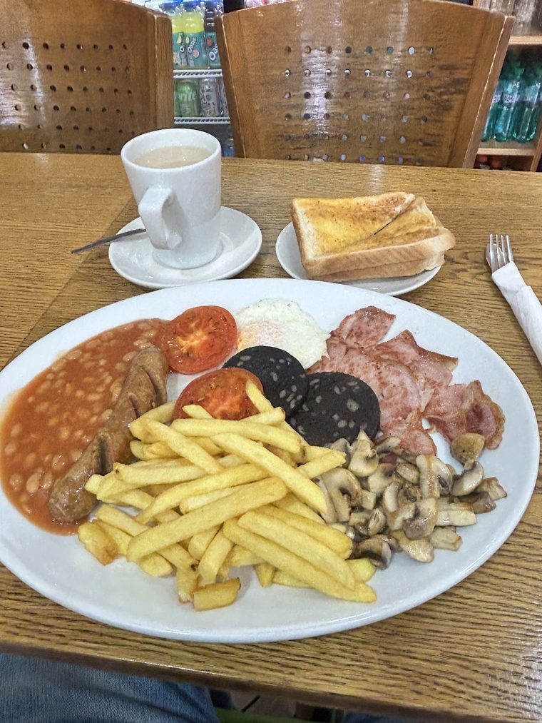 Full English breakfast with chips, beans, black pudding, bacon, sausage and mushrooms