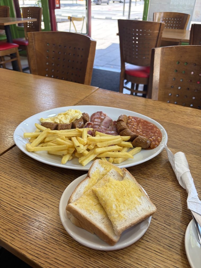 Sausage, bacon and chips with buttered toast